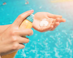 Image of person applying sunscreen