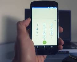 Hand holding smartphone with WiFi calling enabledの画像