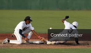 Licensable picture: Ridgeland Roosters player Joshua Snow (18) misses the ball as Clinton Big Wheels player Ethan Kelley (3) slides safely into
