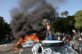Waymo vehicles set on fire in downtown L.A. as protesters, police clash