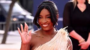 Simone Biles's Feathered Dress Was Worth Being Sewn Into