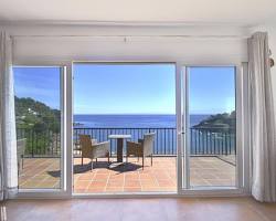 Sunny terrace overlooking the Mediterranean Sea on the Costa Brava in Catalonia, generated by AI