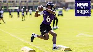 Ja'Kobi Lane catching a football during Baltimore Ravens practice