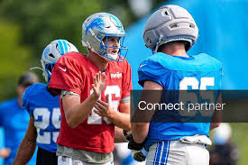 Licensable picture: Detroit Lions quarterback Jared Goff (16), left, talks to center Seth McLaughlin (65) during training camp at Meijer Performance