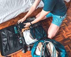 person packing their suitcase for a trip