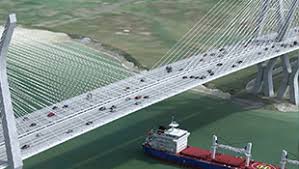 An image of a suspension bridge with a tanker passing beneath