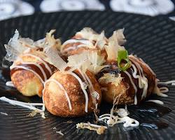 freshly made takoyaki with whole octopus insideの画像