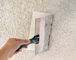 Skim coating being applied for a smooth modern ceiling finish