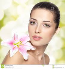 Beauty face of young woman with flower. Beauty treatment concept. Blinking Background. Bokeh. MR: YES; PR: NO - beauty-face-young-woman-flower-beauty-treatment-concept-28611071