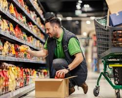 Image of Grocery store worker stocking shelves