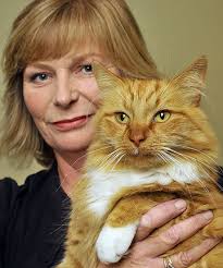 DAVID HALLET. SAFELY HOME: Linda Burnside cuddles her cat, Cashew, which went missing for three weeks after the February 22 earthquake. - 4843046