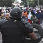 Police battle petrol bombs looting
