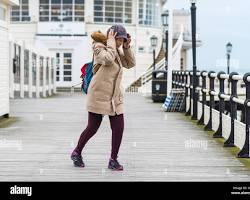 Image of someone holding on to their hat in a windy LA