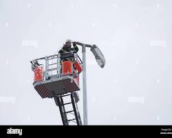 Image of person holding onto a lamppost during an earthquake