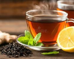 ginger and lemon water in a glass on a bright wooden table, natural sunlight, healthy lifestyle photography، من إنشاء الذكاء الاصطناعي
