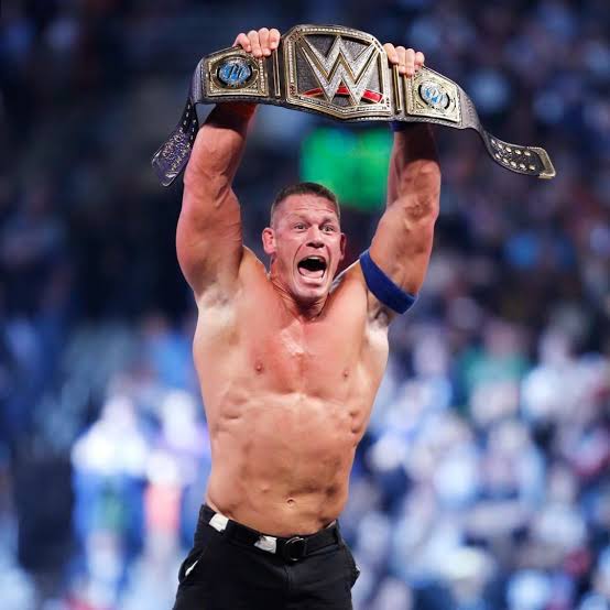 Cena holding a championship belt, not slimmed down and not very human