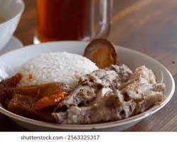 Gambar plate of Gudeg Ceker Margoyudan, with spicy chicken feet and flavorful jackfruit.