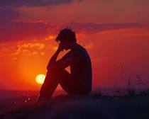 Immagine di man contemplating the meaning of life, sitting alone in a vast landscape