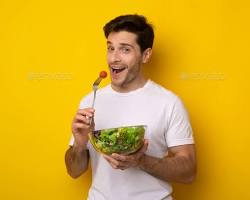 person smiling and holding a bowl of salad 이미지