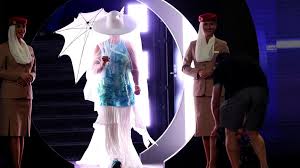 Osaka emerges for Melbourne opener under white hat and umbrella