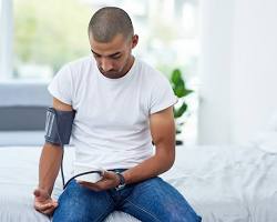 Image of person using a blood pressure monitor