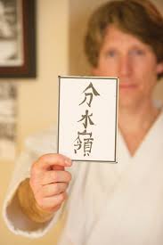 Michael David Bauk holds a card given to him by his own Sensei with the name ...