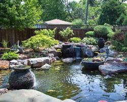 Hình ảnh về garden with large granite stones and a water feature, implying feng shui elements