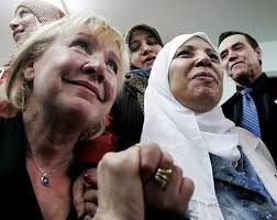 Luce Rivard (left) holds hands with Dr. Najat Boughaba while Mayor Martin ... - image