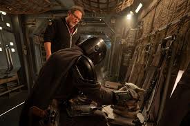 This image, released by Disney, shows director Jon Favreau, left, and Pedro Pascal on the set of Lucasfilm\'s \