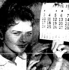Evelyn Wilson, 14, shows off an April calendar that appears to be nailed to a truck tire. The nail is a fake one, designed for such foolishness. - 1960nail