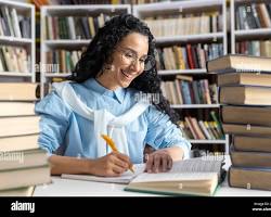 Hình ảnh về student writing an essay, surrounded by books and notes