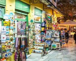 Image of bustling street in a tourist destination, lined with shops, restaurants, and hotels