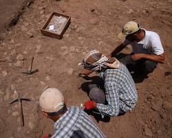 Image of archaeologists working in a tomb, highlighting the ongoing efforts to uncover and preserve its secrets.