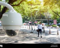 Imagen de person walking through a city street with CCTV cameras