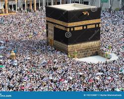 صورة people walking around the Kaaba during Umrah