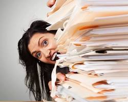 Image of person overwhelmed by piles of medical records
