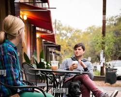 Image of people enjoying coffee in a dog cafe