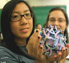 ... holds a geometric sculpture created at a workshop conducted by computer science professor Craig Kaplan, while classmate Deanna Lammers admires. - 0723KirstenLimShad