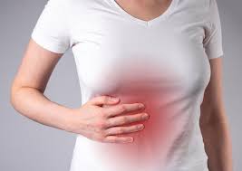 Woman suffering from liver pain hand holding abdomen with ...