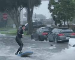 Image of person surfing in a flooded street