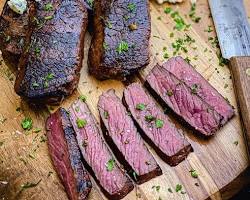 Image of someone grilling venison steaks