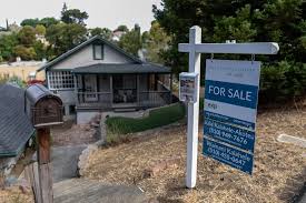 For sale sign outside a home as mortgage rates rise