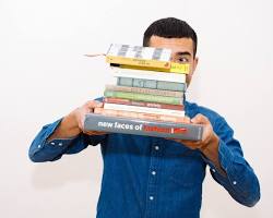 Image of College student carrying textbooks