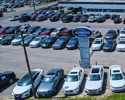 Image of car dealership with a variety of new and used vehicles