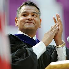 New Mexico Highlands alumnus Hector Hernandez, a 19-year veteran of the U.S. Secret Services, applauds the Class of 2011 May 14 after his keynote speech. - 2011_Commencement1952