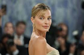 Margot Robbie Radiates in Her Lightest Hair Color in Years and Lacy Butter Yellow Skirt Set in Paris