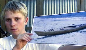 RETURN MY BOAT: Christchurch teenager Cooper Davis holds a photo of the kayak he built with his father. The boat was stolen after its first voyage, ... - 4643691