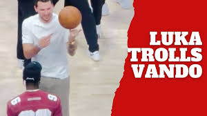 Luka Doncic jokes with Vando while spinning the ball before the game
