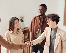 Image of group of people laughing and shaking hands