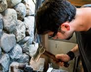 Image of Tourists participating in a metalworking workshop